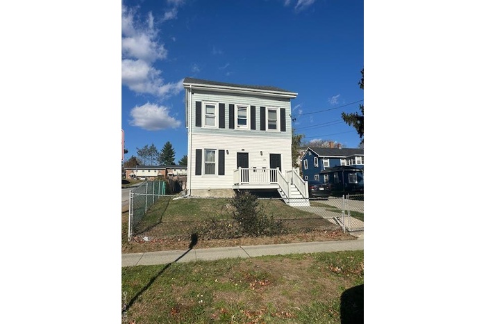 View of front of home with a gate and a wooden deck