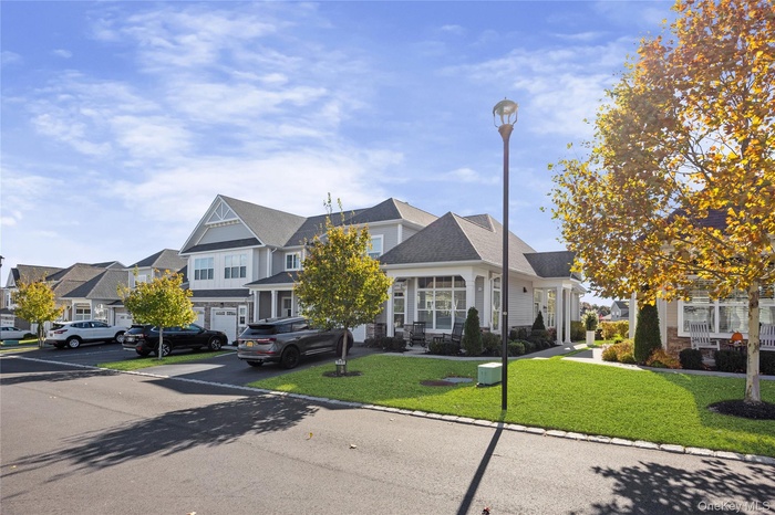 View of front facade with a front lawn and roof with shingles