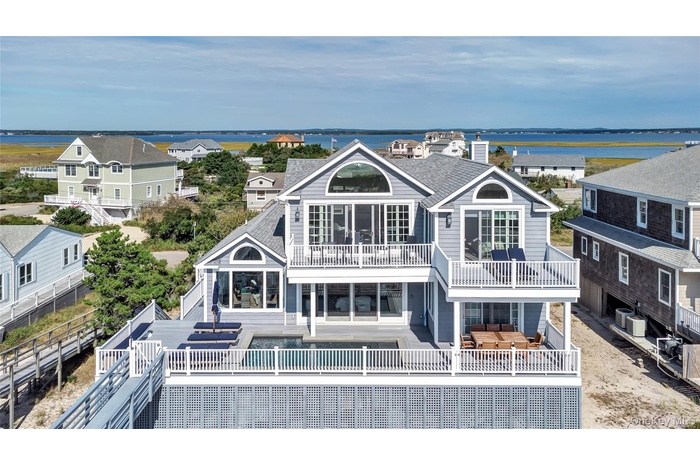 Rear view of property with an outdoor living space, a water view, and a fenced backyard