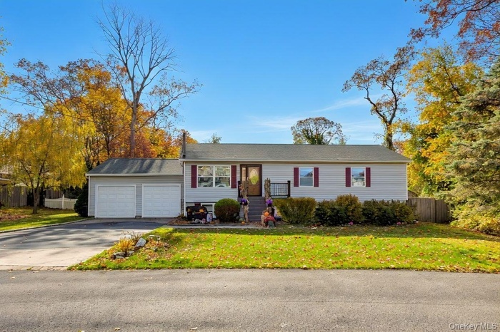 Single story home featuring driveway and an attached garage