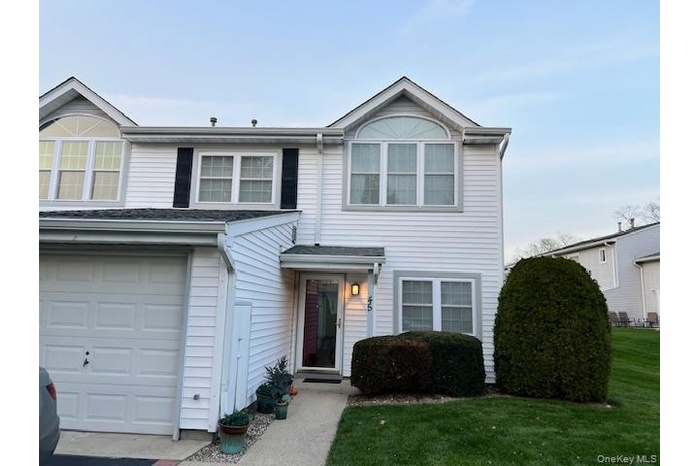 Traditional home with a front lawn
