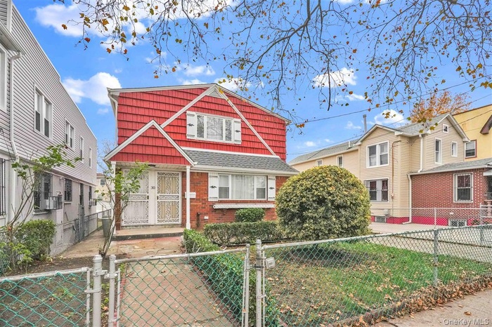 View of front of home featuring a gate and a fenced front yard