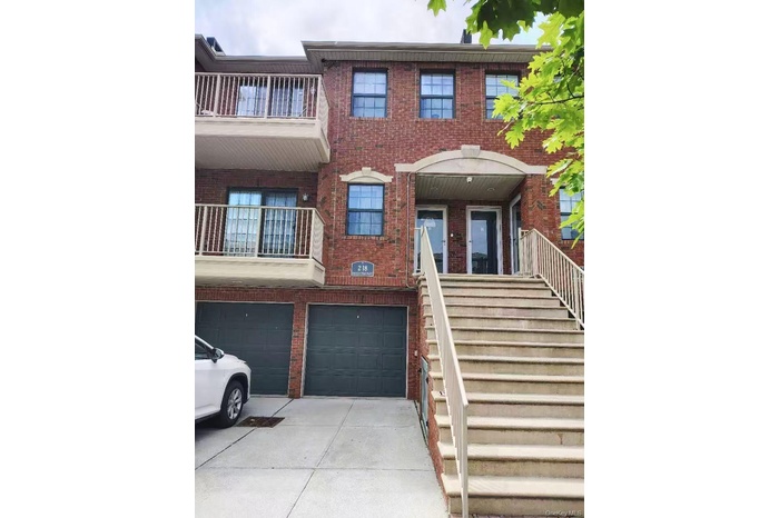 Multi unit property featuring stairs and brick siding