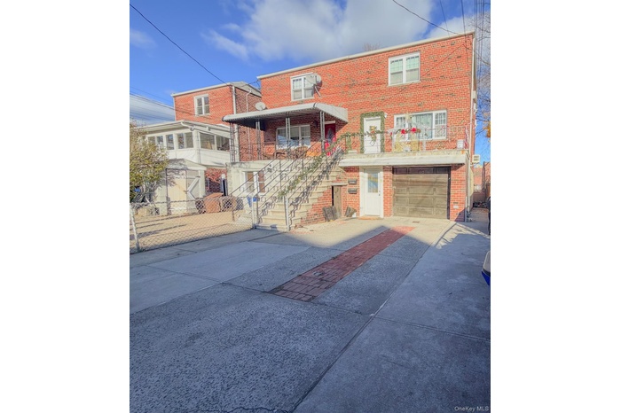 Traditional home with concrete driveway, stairway, brick siding, and a garage