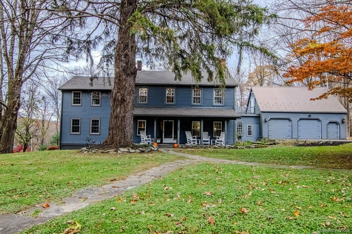 Colonial Home with rocking chair porch and attached 2 plus car garage