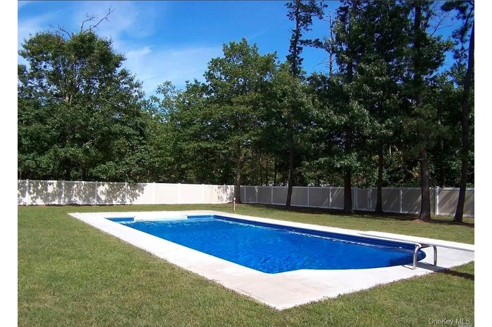 View of swimming pool featuring a fenced backyard and a patio