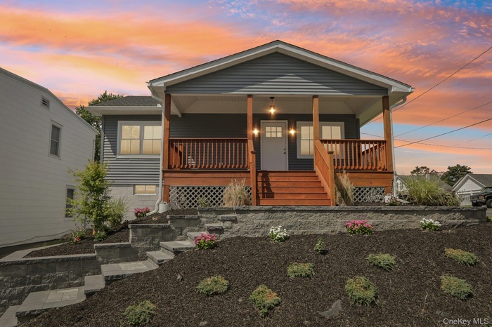 View of front of home with a porch and stairway