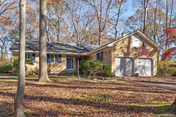 Single story home with driveway with garage