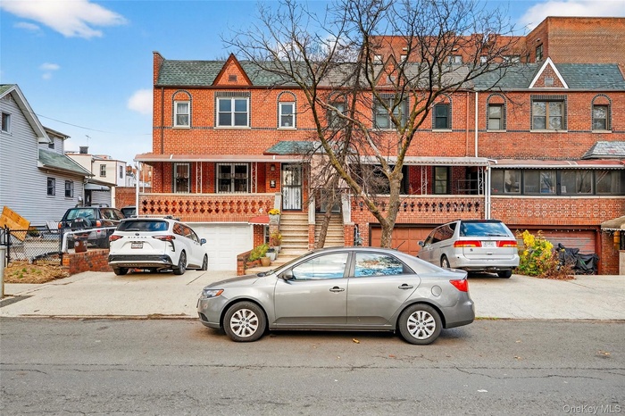 View of front of property featuring brick siding and stairway