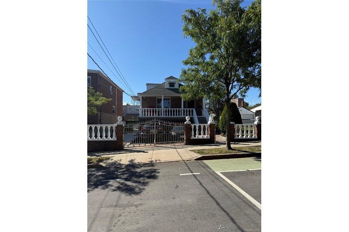 Bungalow-style house featuring a fenced front yard, a gate, and brick siding