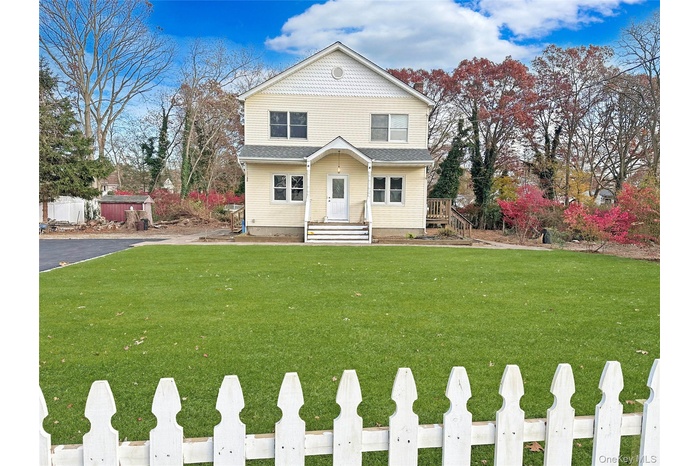 View of front of home with a front lawn and a porch