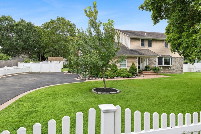 View of front of house featuring a fenced front yard, stone siding, and a fence