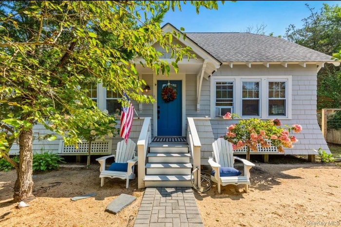 View of front of property with roof with shingles