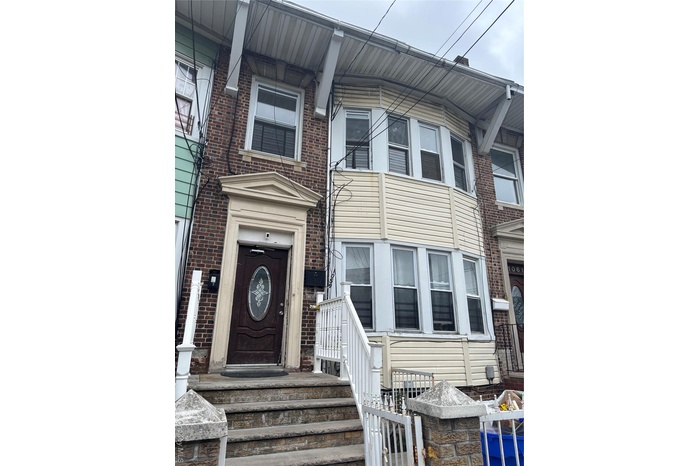 Entrance to property featuring brick siding