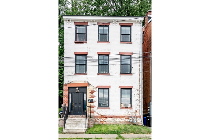 View of front of home featuring brick siding
