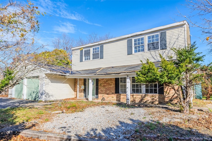 Traditional-style home featuring brick siding and an attached garage