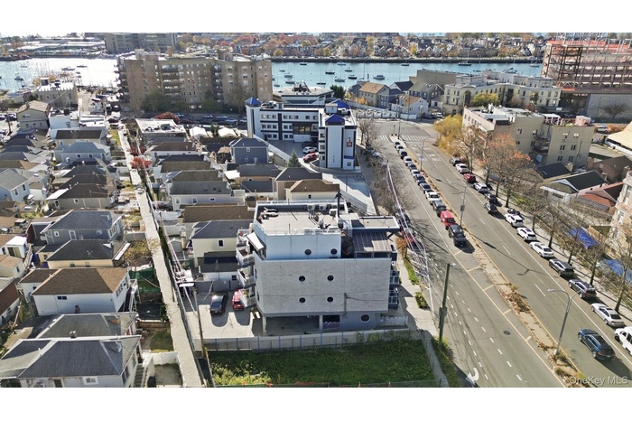 Aerial view of property's location with a nearby body of water and nearby urban area