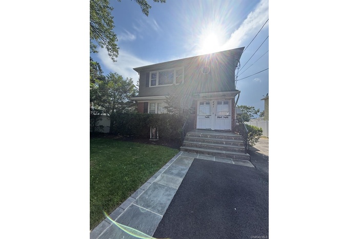 View of front facade with a front lawn and brick siding