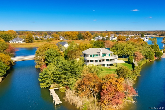 Bird's eye view of a nearby body of water and a tree filled landscape