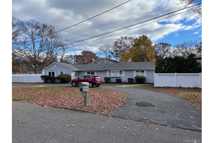 Single story home with asphalt driveway