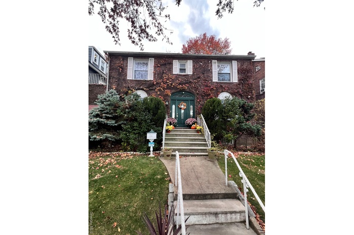 View of front of house with a front yard and brick siding