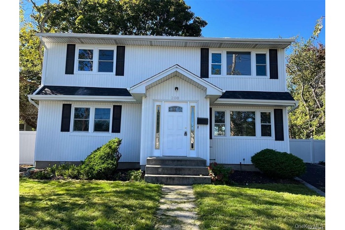 View of front of property featuring roof with shingles