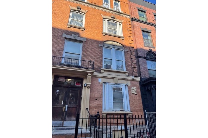 View of property featuring a fenced front yard