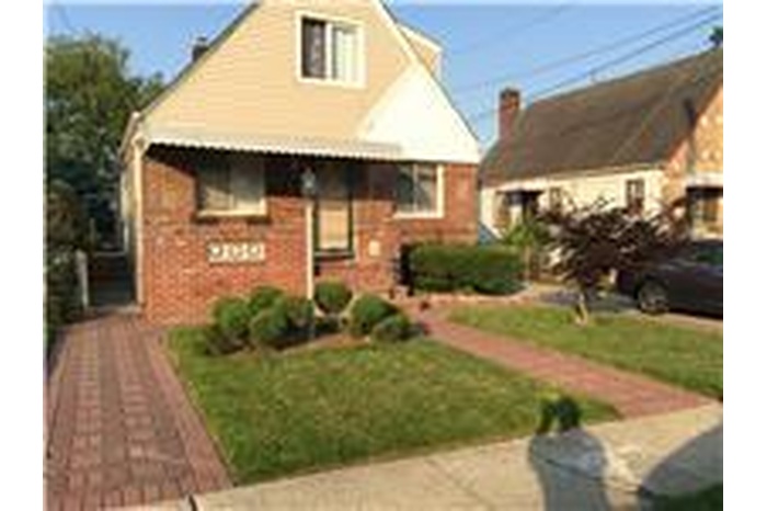 Bungalow-style home with brick siding