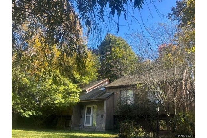View of side of home with a lawn
