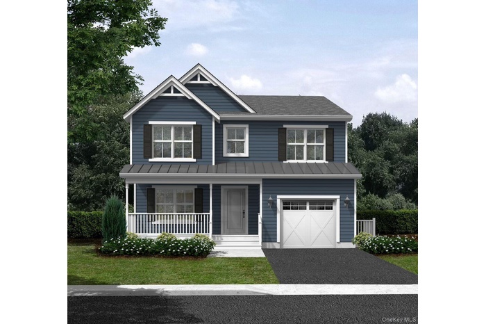 View of front of home featuring covered porch, a standing seam roof, driveway, a garage, and a metal roof
