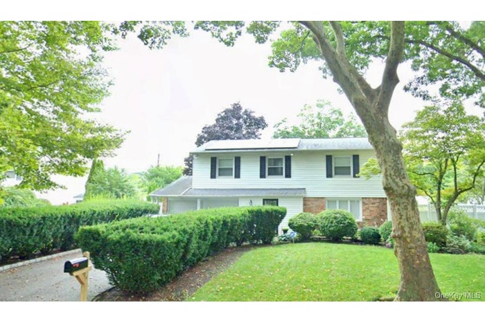 View of front facade with solar panels and brick siding