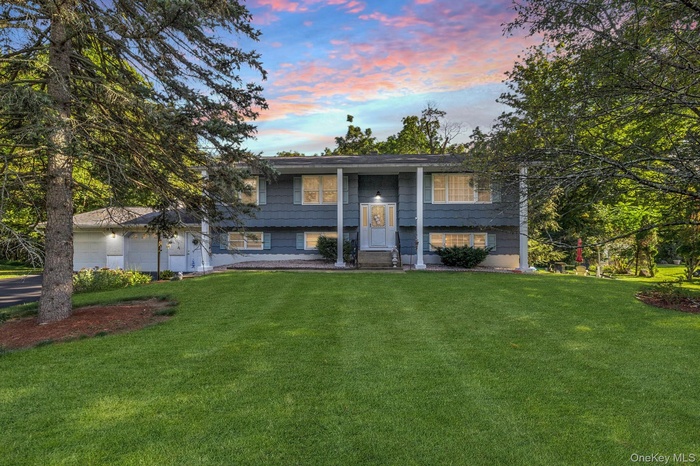 Raised ranch featuring a lawn