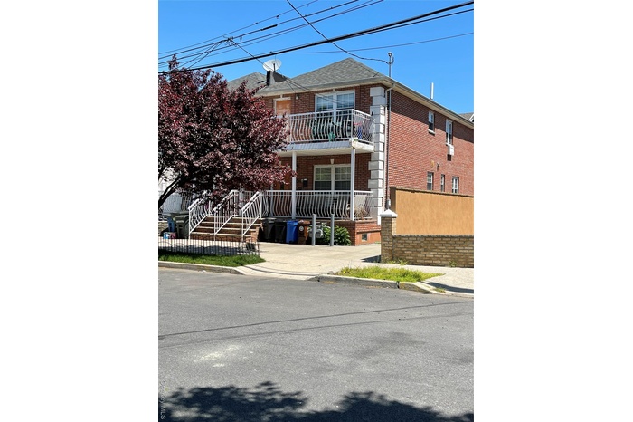 Traditional-style house with a balcony and brick siding