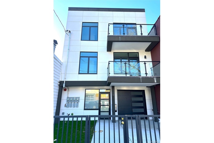 View of front of property with a balcony and stucco siding