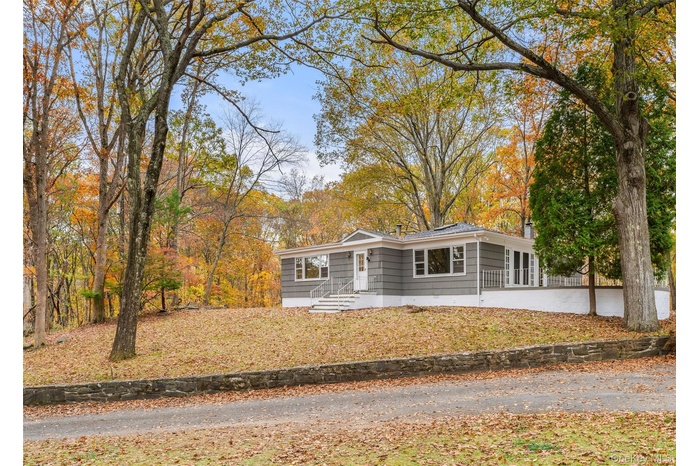 Ranch-style home featuring a chimney