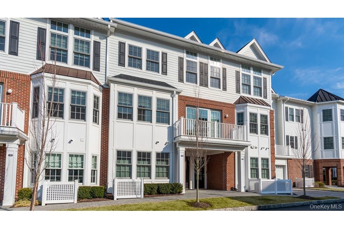View of front of house with a balcony, brick siding, and a residential view