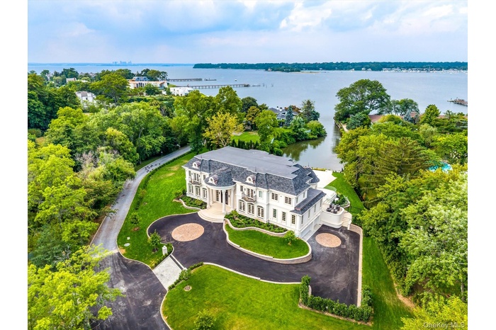 Drone / aerial view of a large body of water and a tree filled landscape