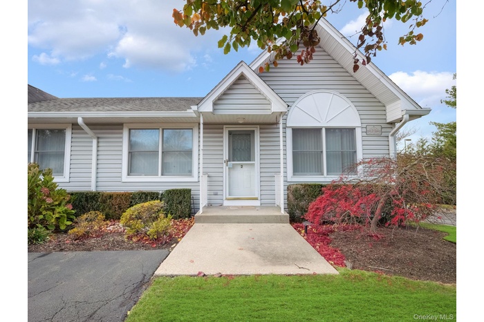View of front of home featuring a front yard and roof with shingles