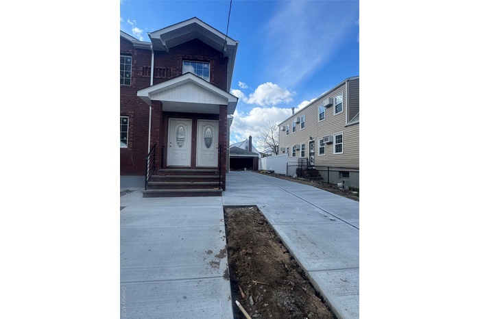 Doorway to property featuring brick siding and board and batten siding