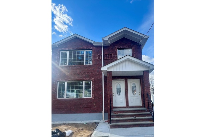 View of front of property featuring brick siding