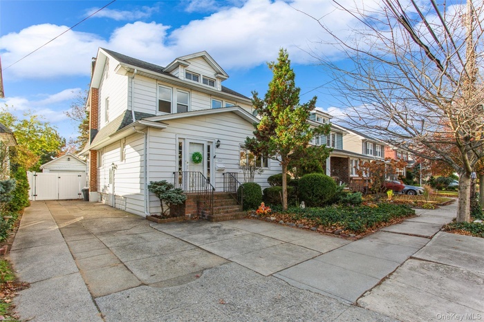 View of front facade with long driveway & fenced yard