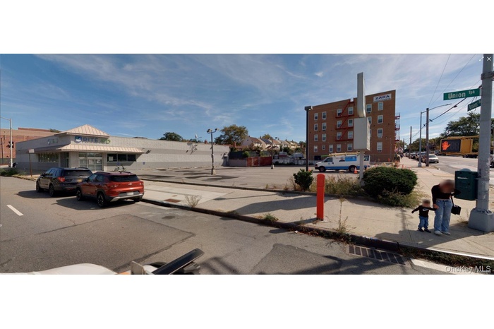 View of asphalt street with street lighting, sidewalks, and curbs