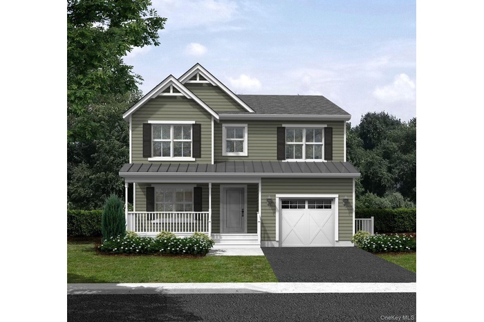 View of front of house with a standing seam roof, covered porch, driveway, a garage, and a metal roof