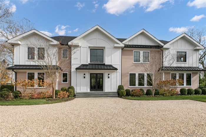 Modern farmhouse style home with a standing seam roof, a metal roof, and board and batten siding