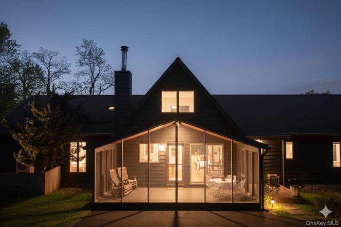 Rear view of property featuring a chimney