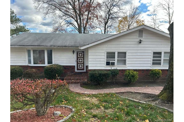 Ranch-style home featuring brick siding