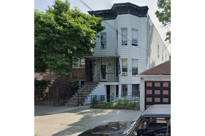 Italianate-style house featuring an outbuilding, a balcony, and stairs