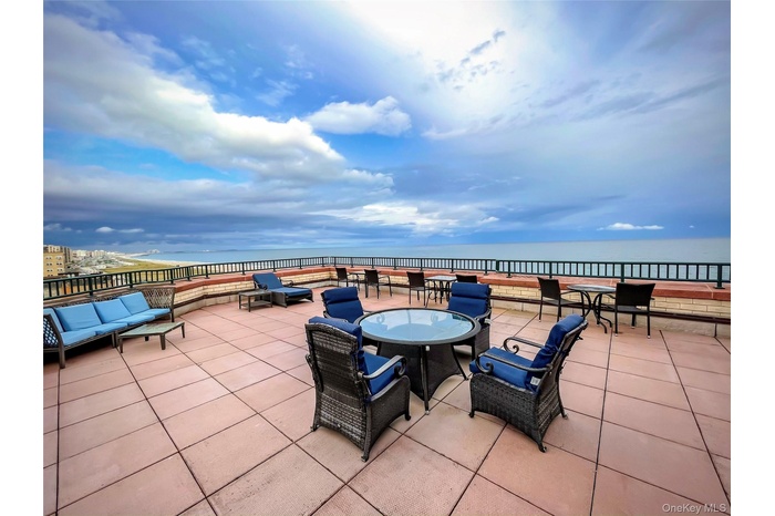 View of patio / terrace featuring a water view, outdoor dining area, and an outdoor hangout area