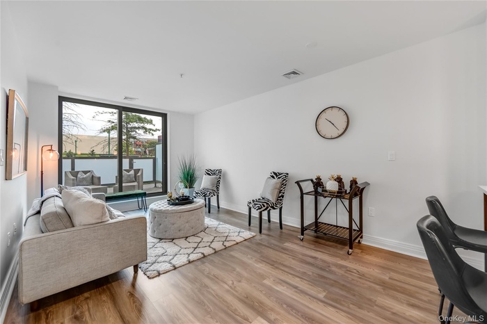Living room with light wood-type flooring and a water view