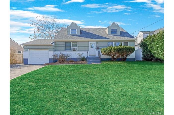 Cape cod home featuring driveway, roof with shingles, and a garage